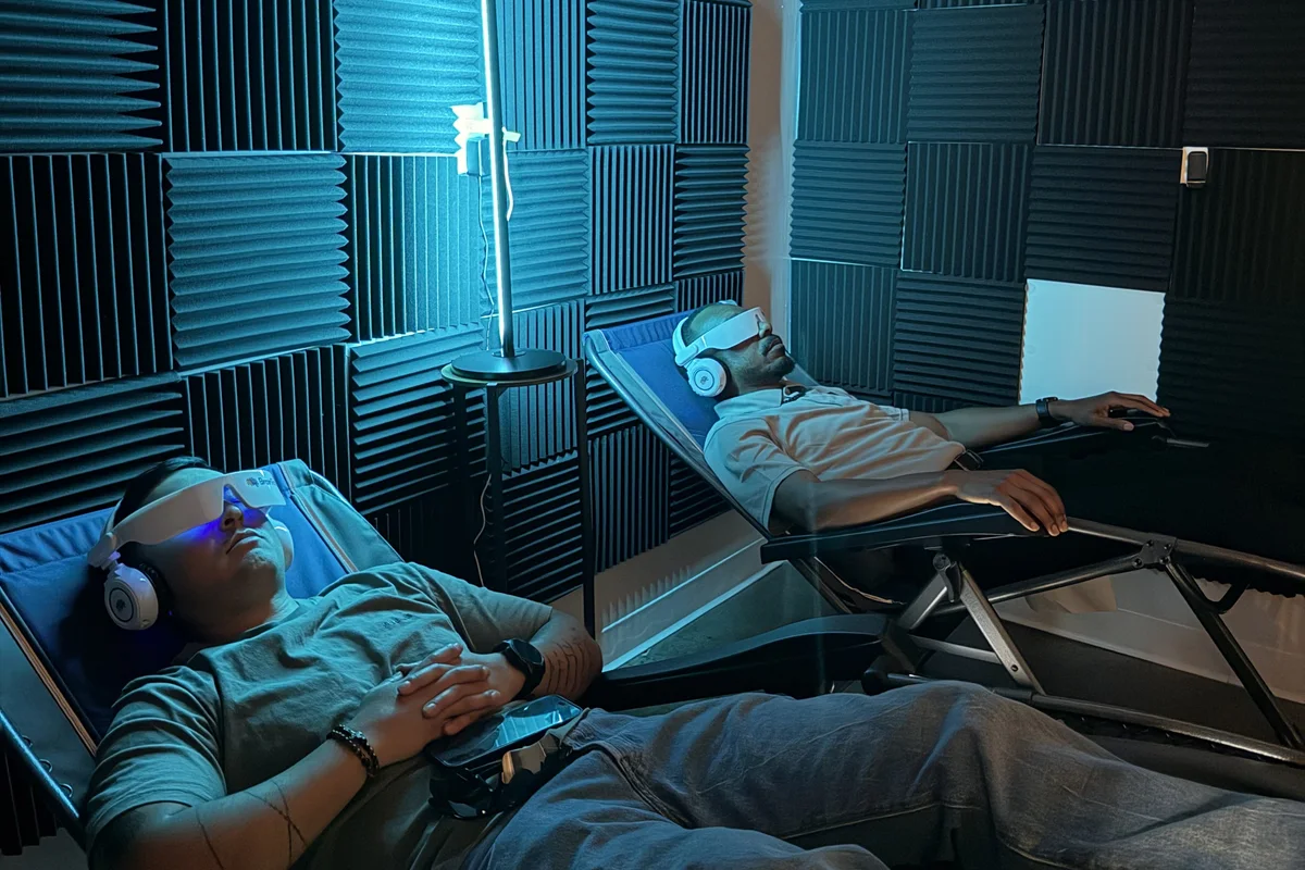 Two clients relaxing in zero-gravity recliners during BrainTap sessions at Alma Sana Chiropractic Studio
